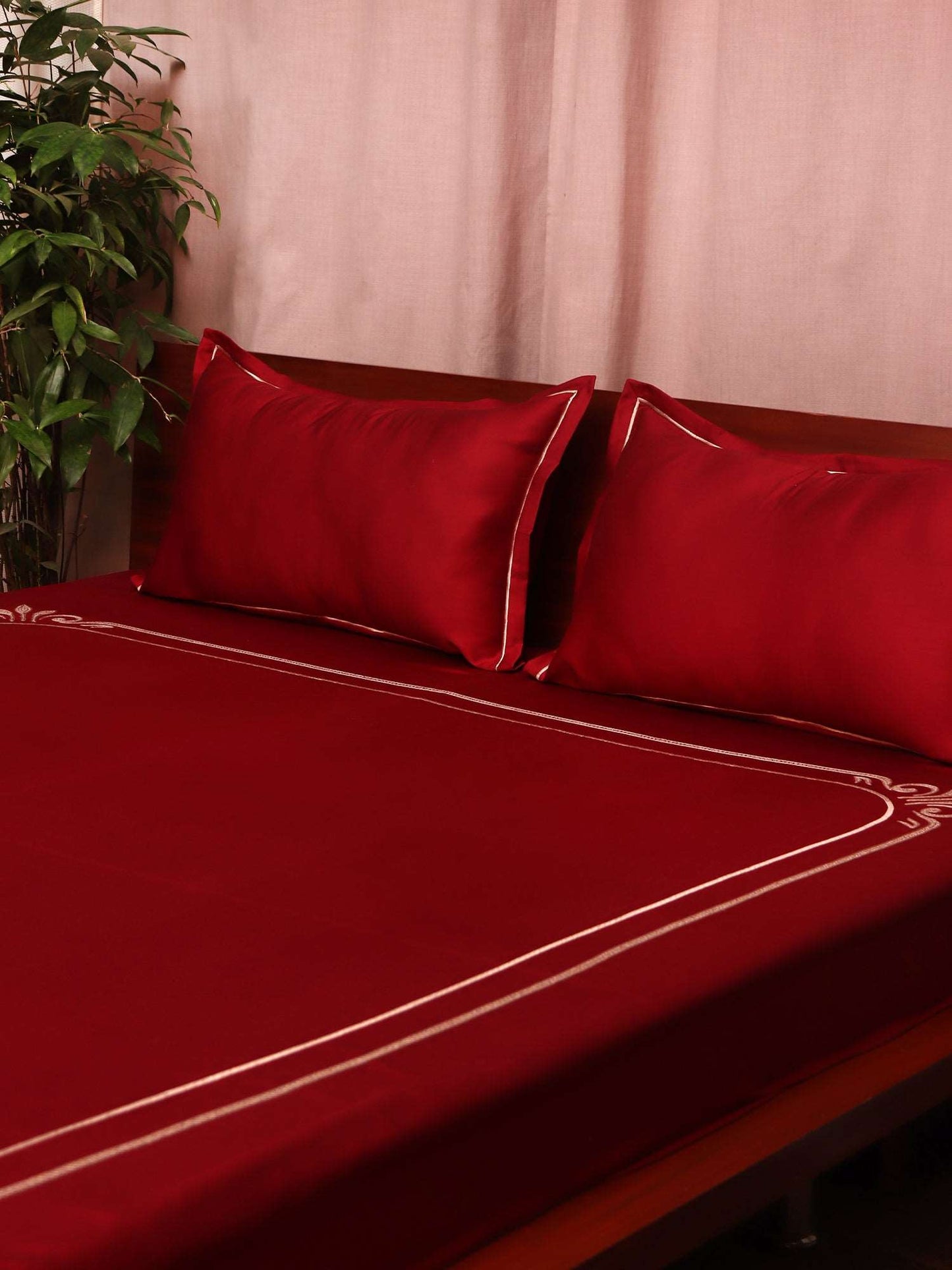 side view of maroon colored embroidered soft premium bedsheet with 2 matching pillow covers made from 100% pure cotton for king size double bed in 300 thread count