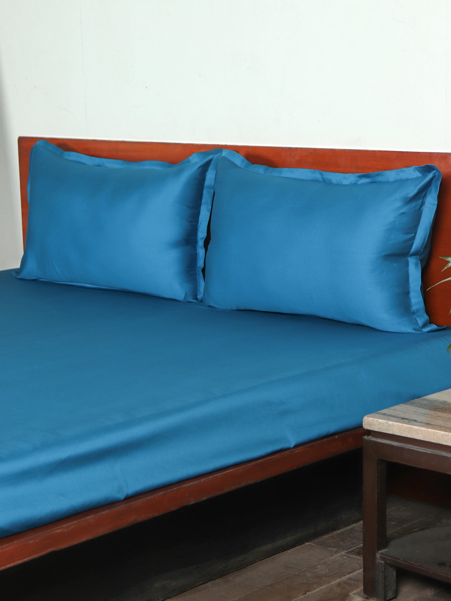 side view of Blue colored plain soft bedsheet with 2 matching pillow covers made from 100% pure cotton for king size double bed in 400 thread count fabric