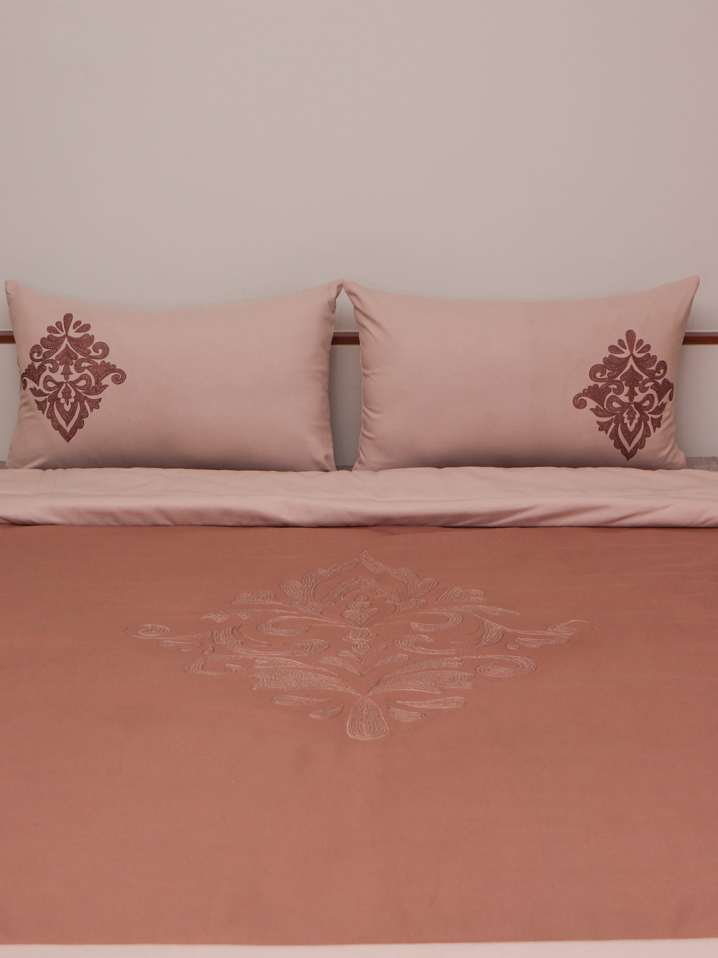 Coral colored embroidered bed quilt /comforter with 2 matching pillow covers made from cotton blended front and cotton backed quilt for king size double bed 