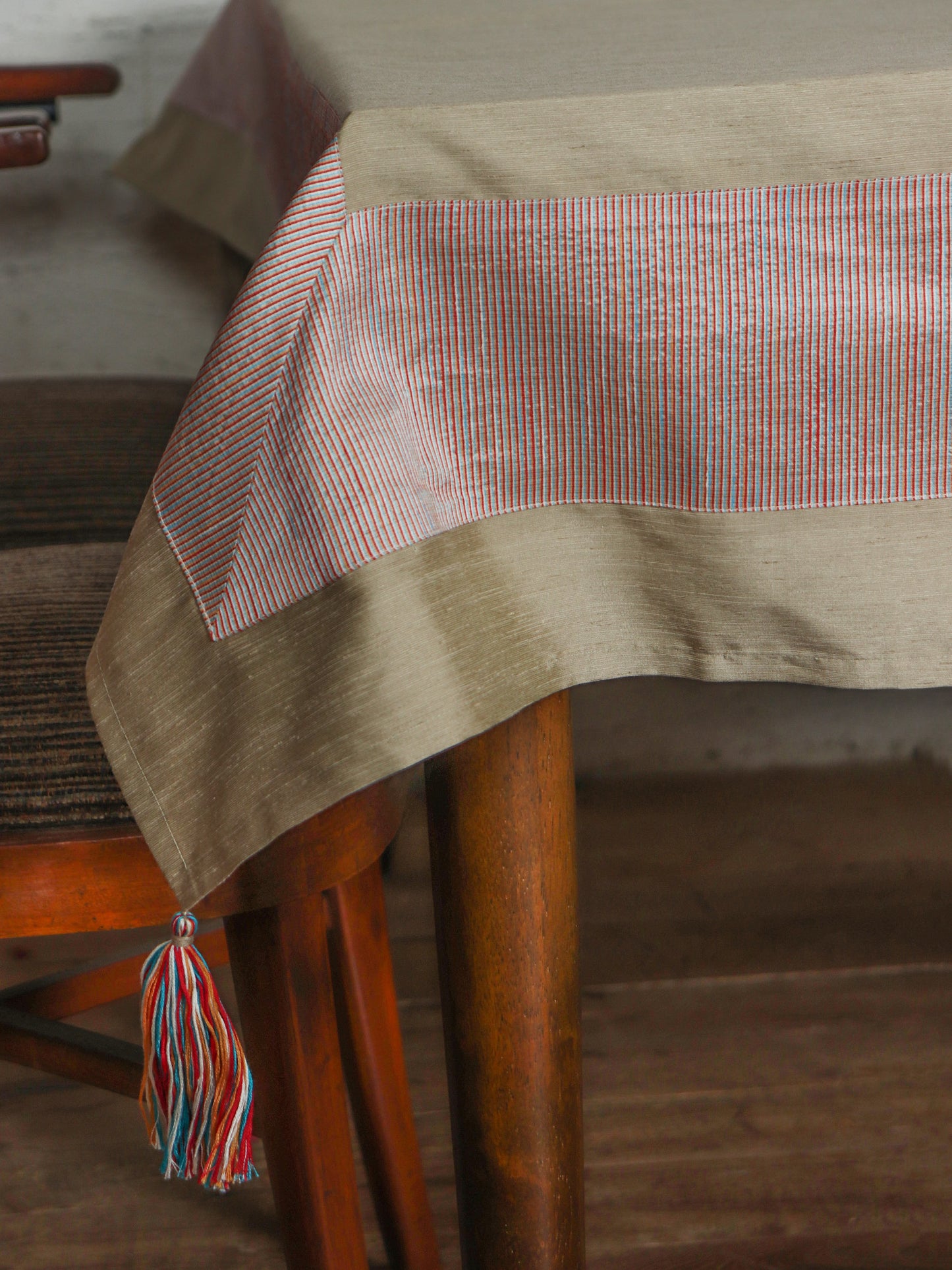 gold colored table cover with benarasi brocade silk panel border and multicolored tassels for 6 seater table 52x84 inches