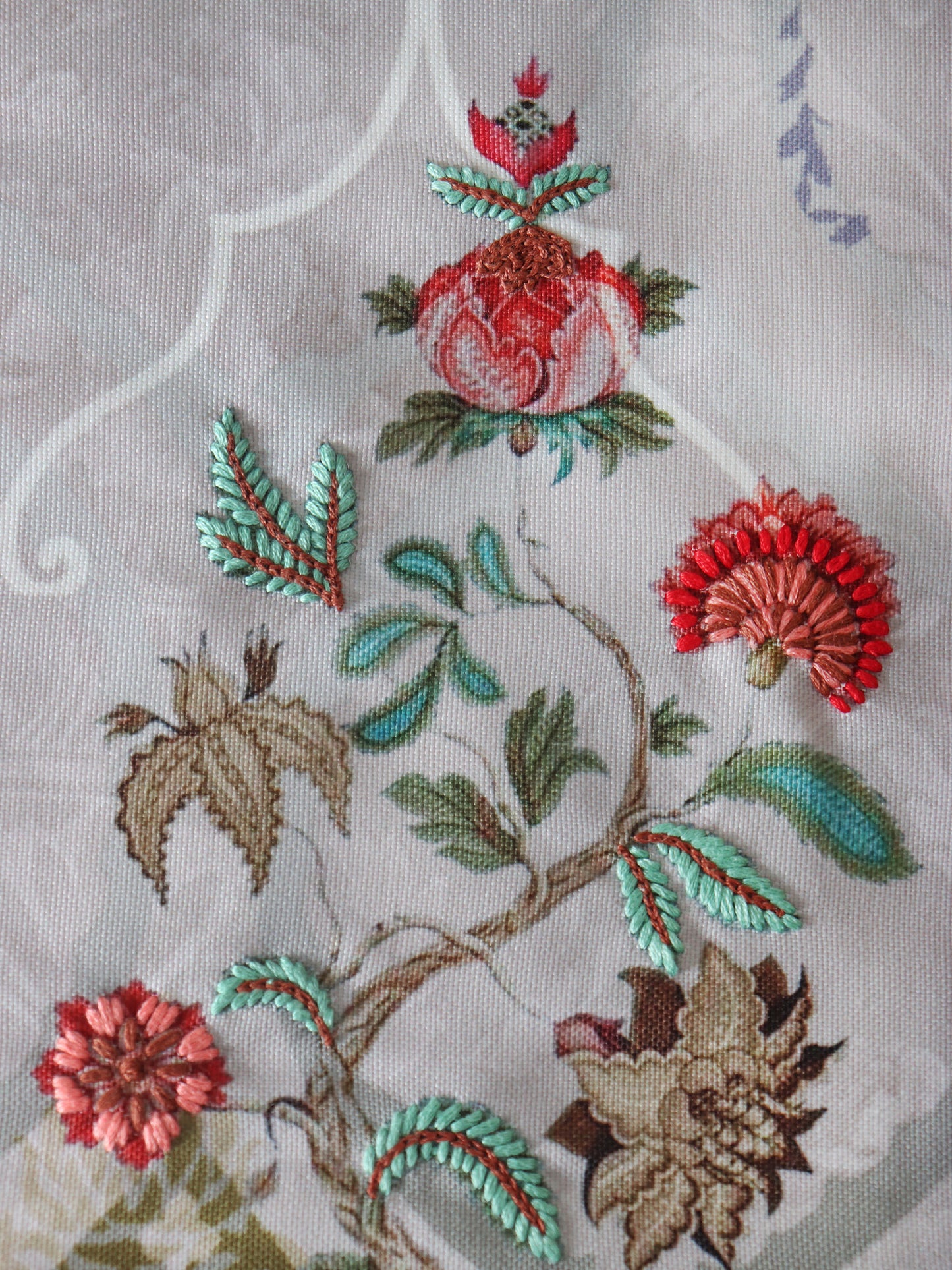 closeup of aesthetic floral hand embroidery on blue table runner - 12x84 inch