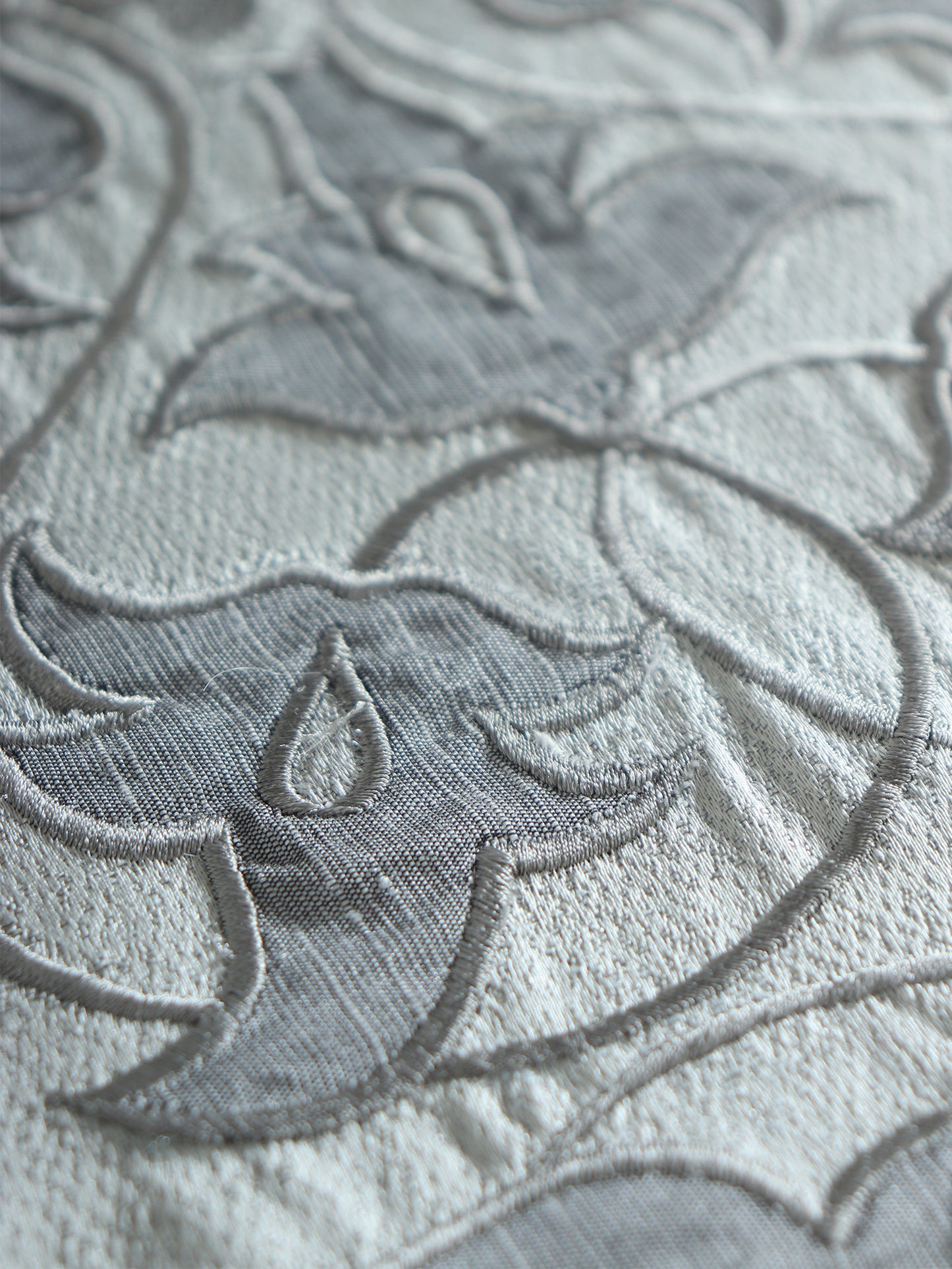 closeup of floral embroidery with hand crafted applique design on gray table runner - 12x84 inch