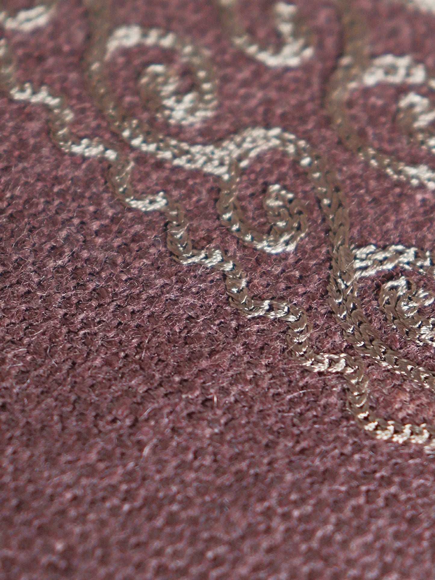 closeup of embroidery on violet table cover for 6 seater table