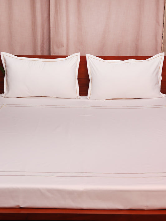 close up of white colored embroidered soft bedsheet with 2 matching pillow covers made from 100% pure cotton for king size double bed in 300 thread count fabric