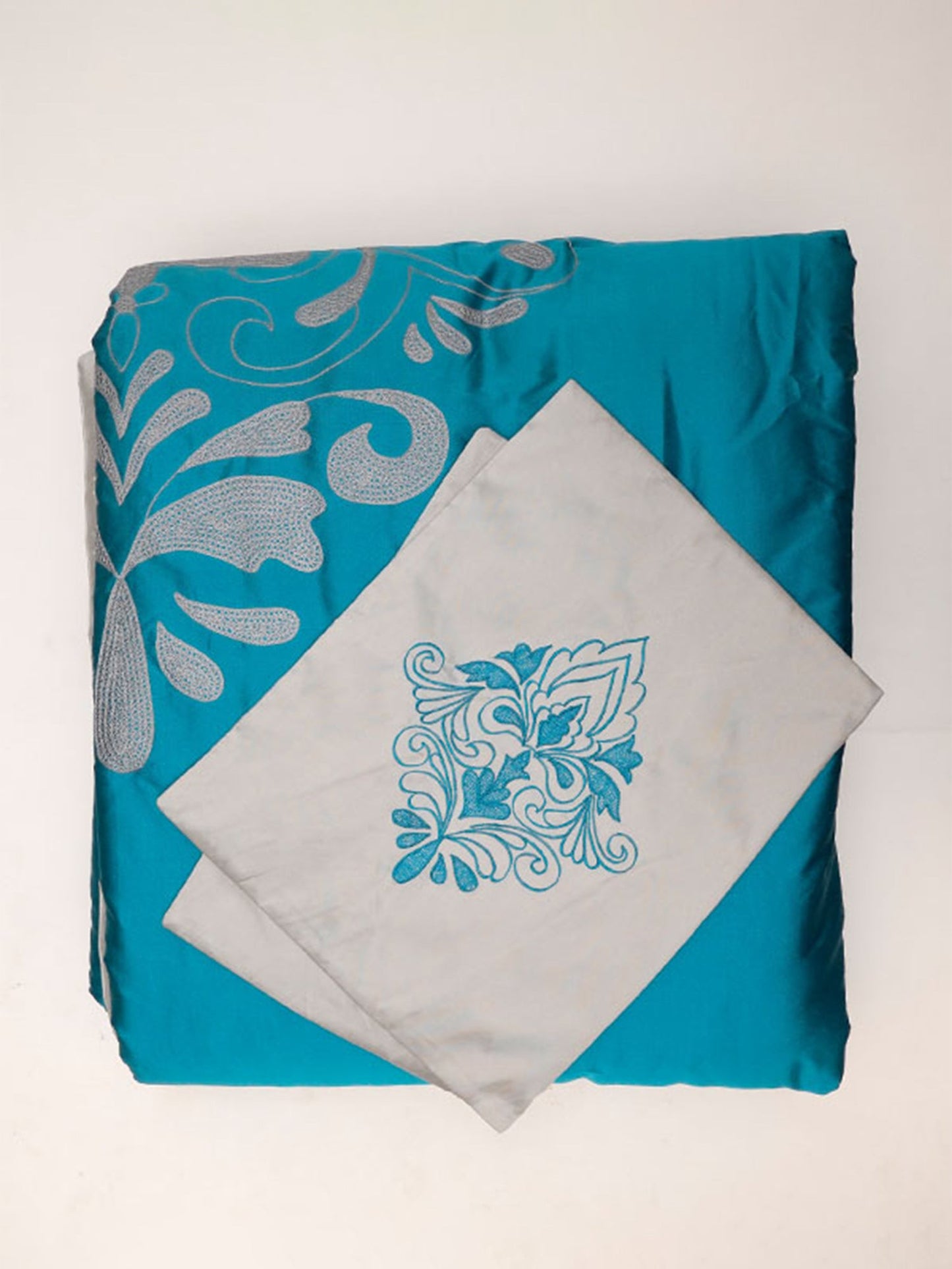 Turquoise blue colored embroidered bed quilt with 2 matching pillow covers made from polyester front adn cotton backed quilt for king size double bed 