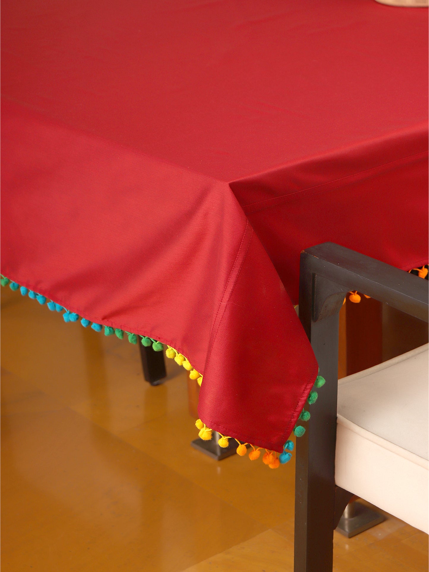 red colored 6 seater table cover with multicolored pompoms - 52x84inches