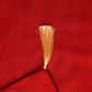 closeup of tassels on red colored embroidered table runner