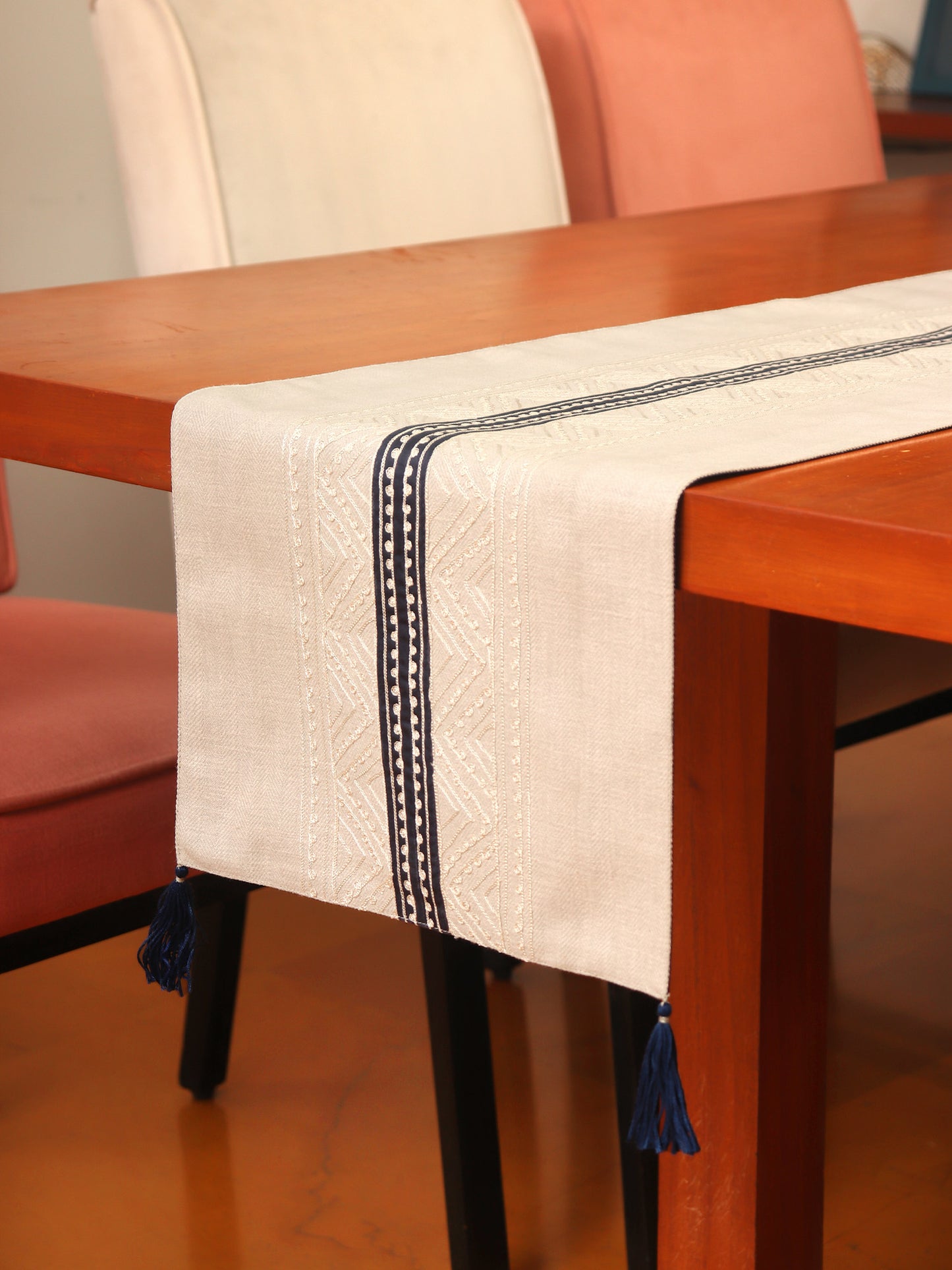 grey colored embroidered table runner with tassels on corners for 6 seater table - 52x84 inches.