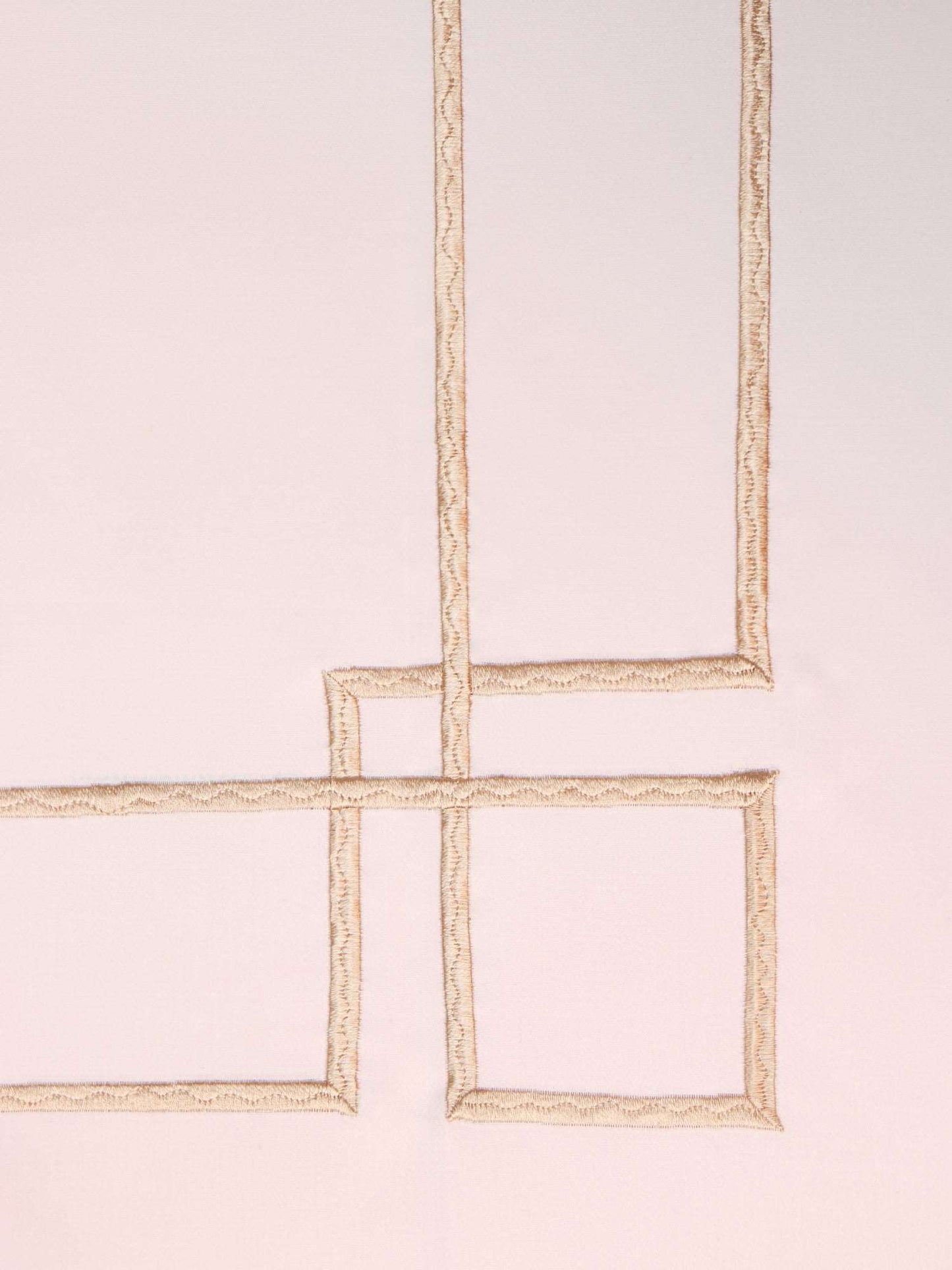 close up of embroidery done on white colored bedsheet made from 100% cotton and 300 thread count