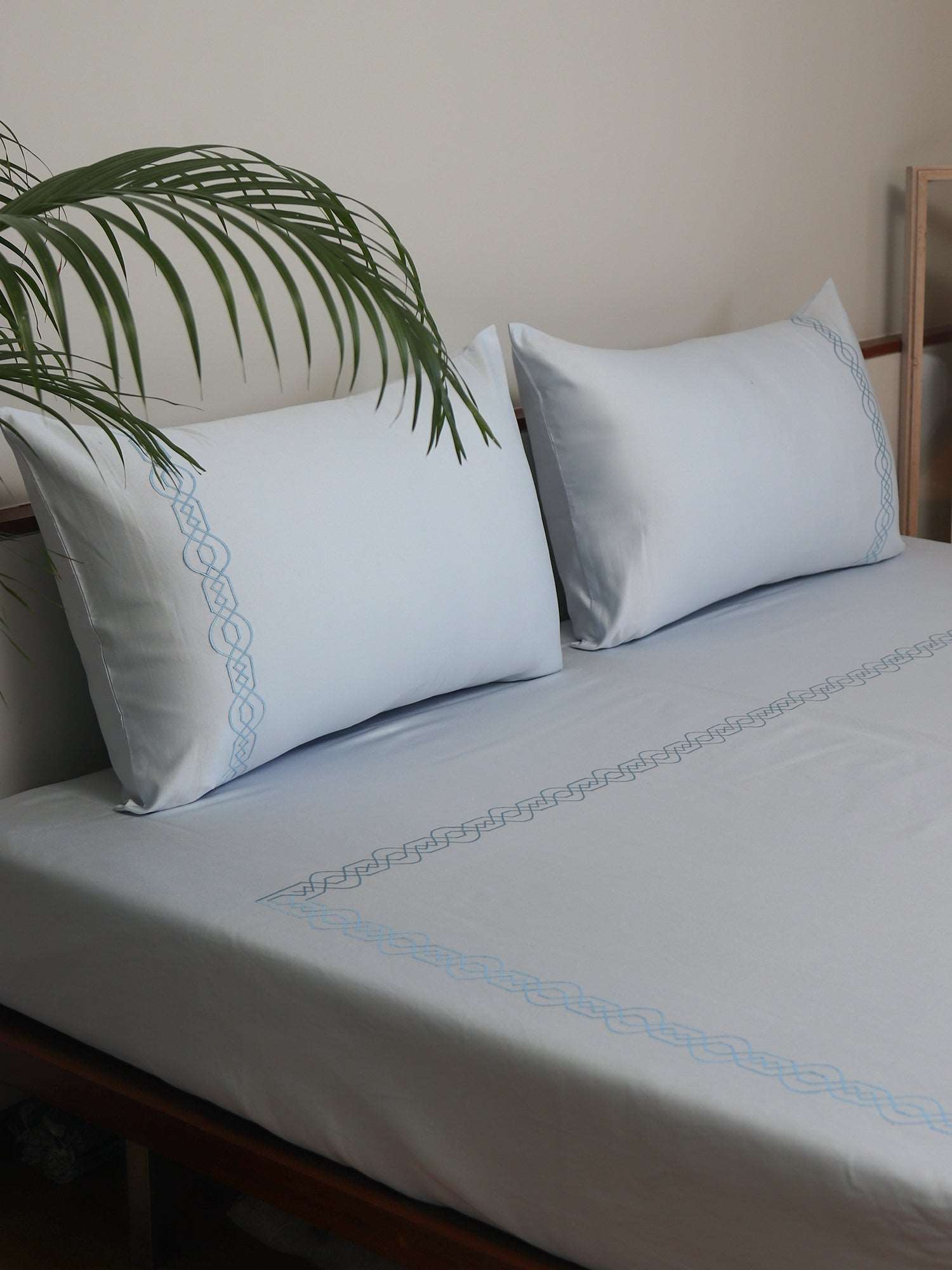 side view of light blue colored embroidered soft bedsheet with 2 matching pillow covers made from 100% pure cotton for king size double bed in 700 thread count fabric