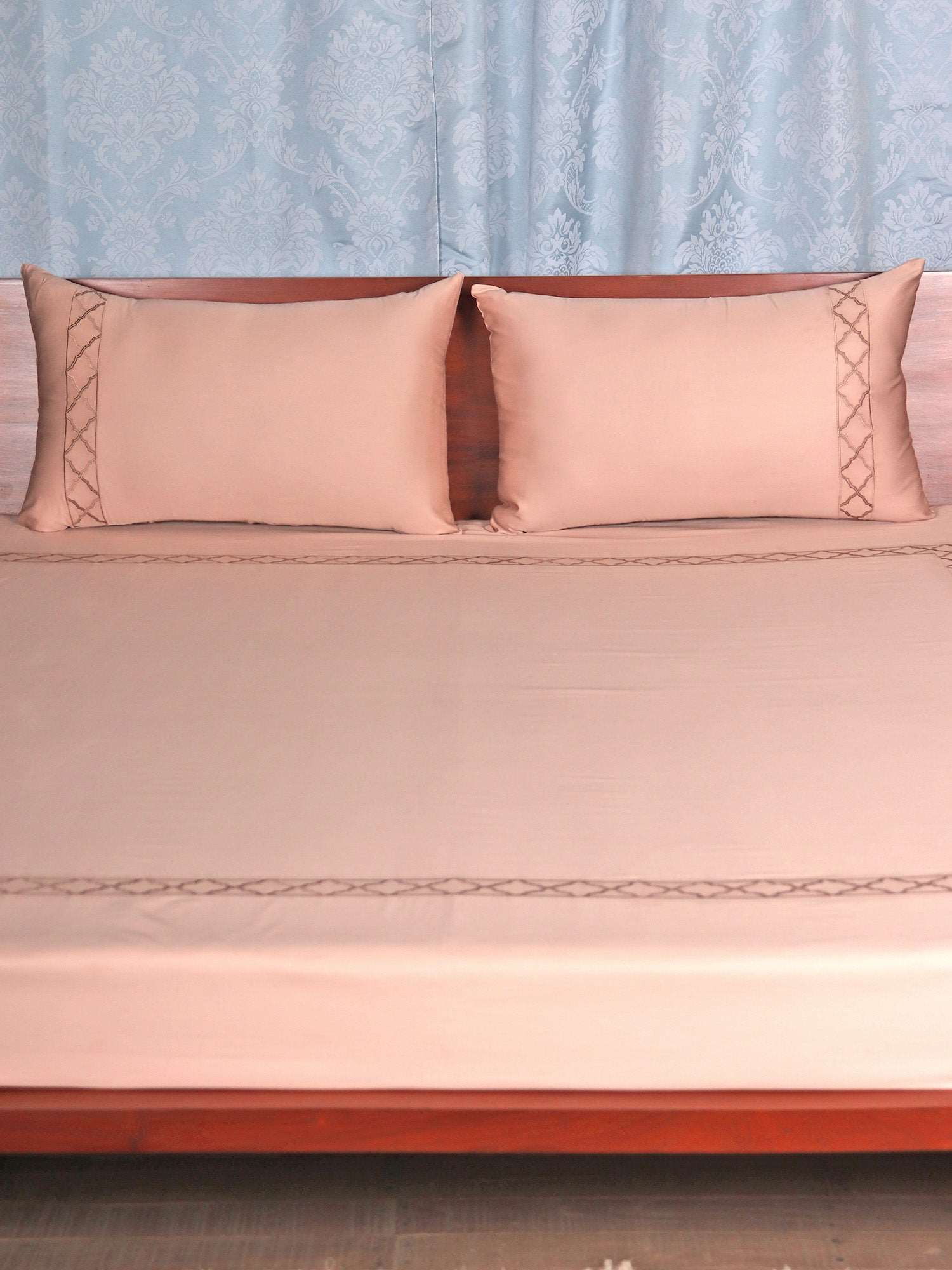 Blush pink colored embroidered soft bedsheet with 2 matching embroidered pillow covers made from 100% pure cotton for king size double bed in 700 thread count fabric