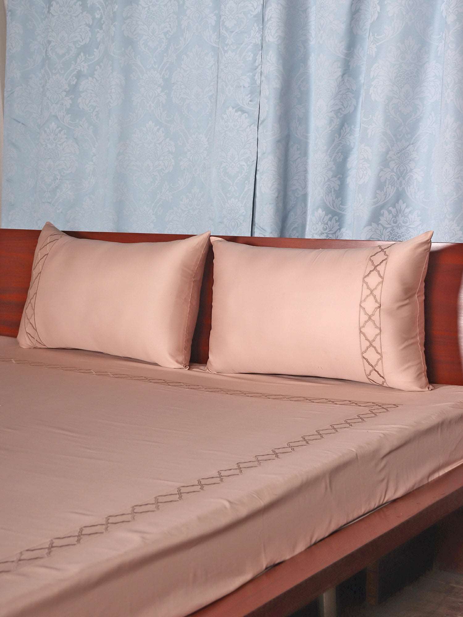 side view of Blush pink colored embroidered soft bedsheet with 2 matching embroidered pillow covers made from 100% pure cotton for king size double bed in 700 thread count fabric