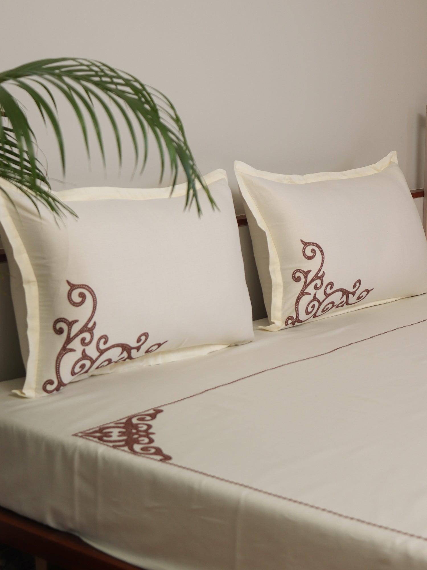 side view of off white colored embroidered soft bedsheet with 2 matching pillow covers made from 100% pure cotton for king size double bed in 400 thread count fabric