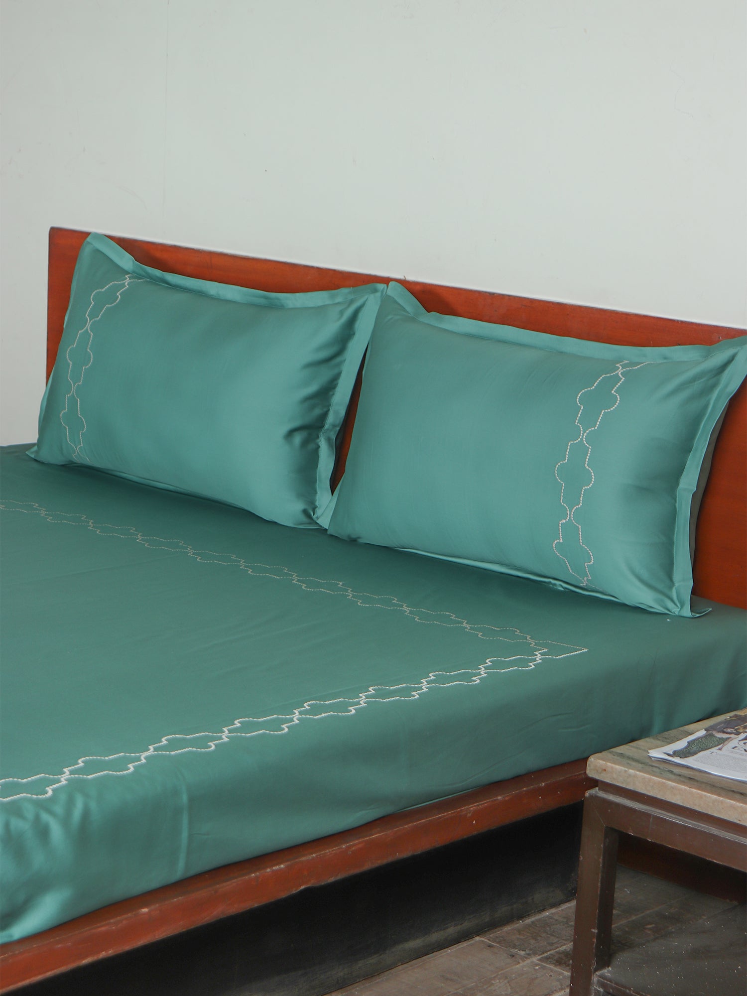 side view of green colored embroidered soft bedsheet with 2 matching pillow covers made from 100% pure cotton for king size double bed in 400 thread count fabric