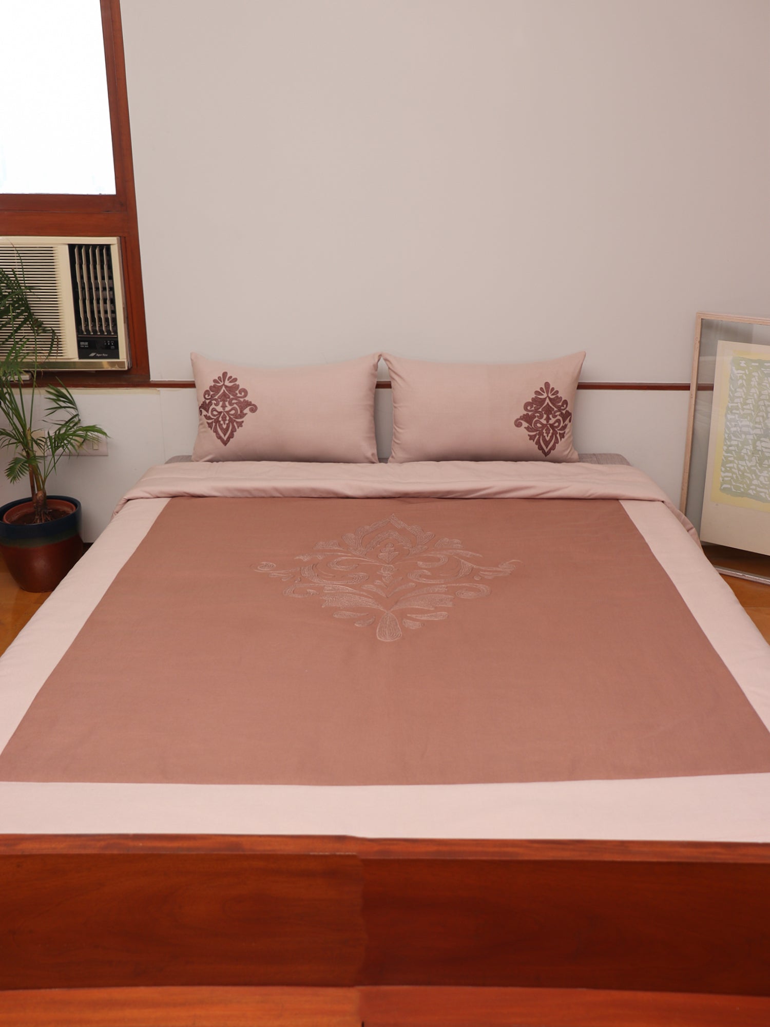 Coral colored embroidered bed quilt /comforter with 2 matching pillow covers made from cotton blended front and cotton backed quilt for king size double bed 