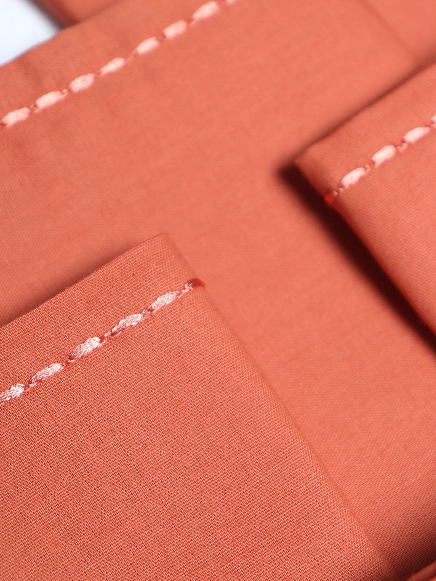 closeup of chawal taka hand embroidered set of 6 dinner napkins in dark coral  color - 16x16 inch