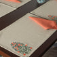 floral embroidered dining table mats and contrast napkins in chawal taka embroidery in beige and rust color combo - 13x19 inch