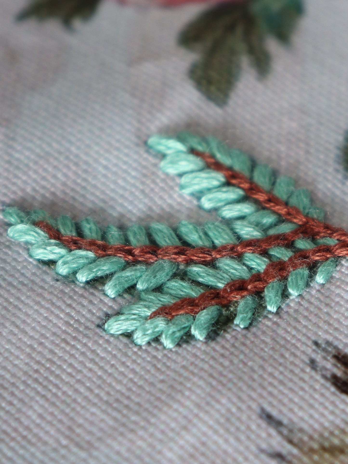 closeup of aesthetic floral hand embroidery on blue table runner - 12x84 inch