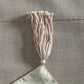 tassels on beige table runner which has floral embroidery - 12x84 inch