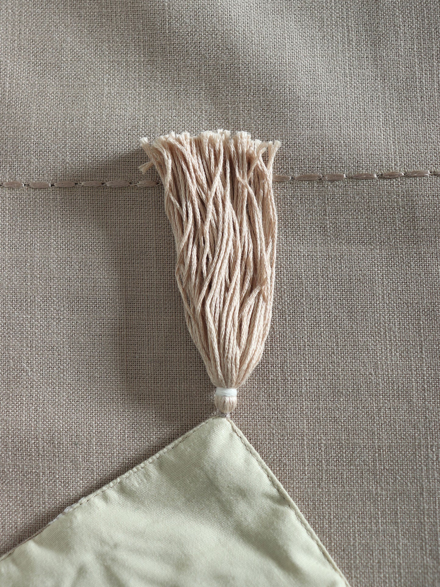 tassels on beige table runner which has floral embroidery - 12x84 inch