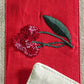 closeup of red floral embroidery in center patch on beige table runner for 6 seater dining table -  12x84 inches