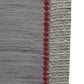 closeup of red embroidery on gray table runner
