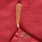 closeup of golden tassels on red colored tablerunner 
