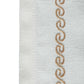 wavy patterned embroidery in golden color on an offwhite table runner