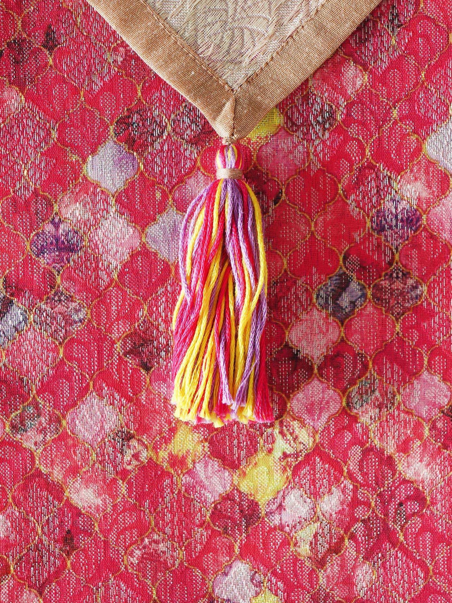 closeup of tassels on pink brocade silk table runner for 6 seater dining table - 12x84 inch