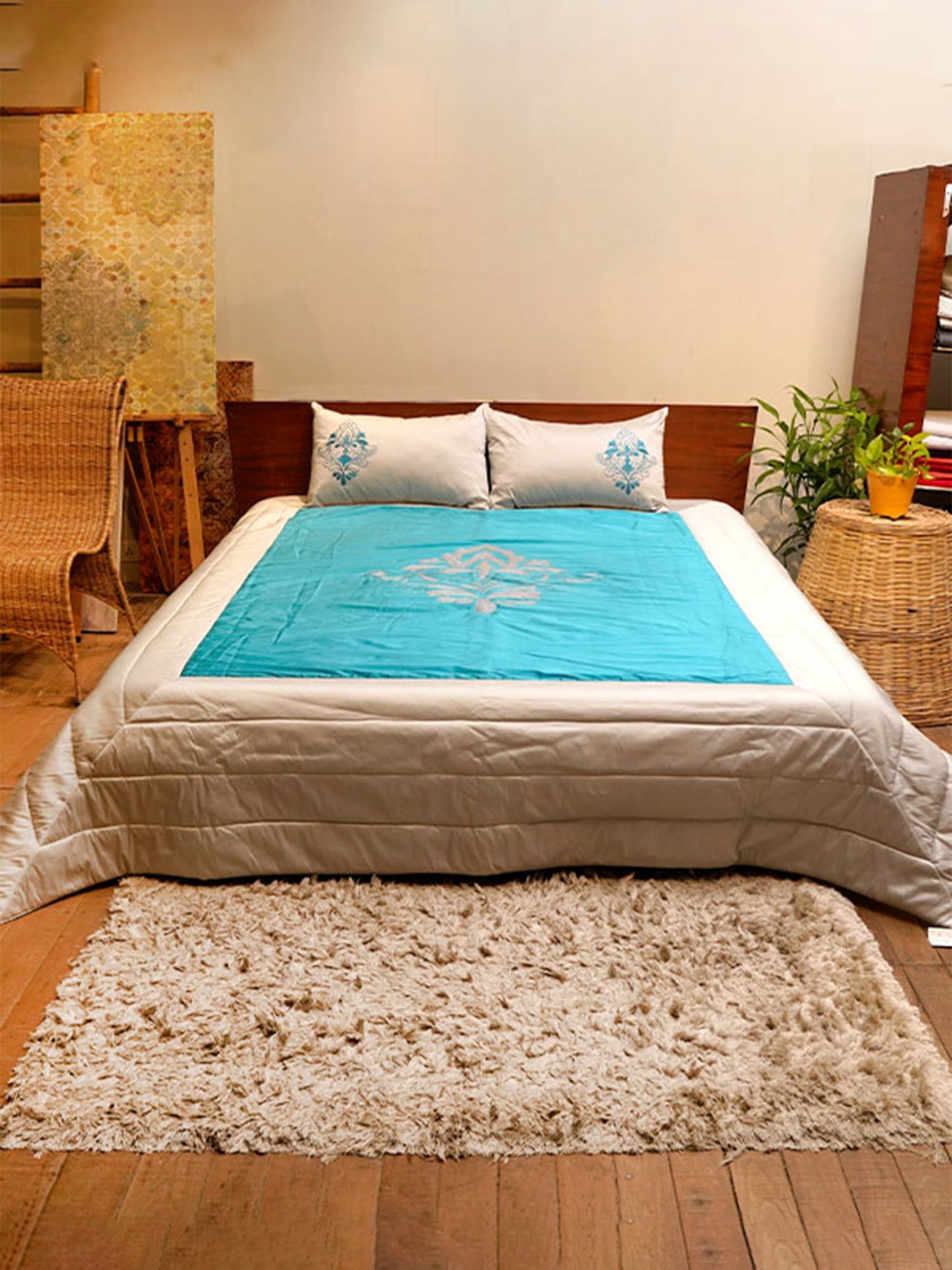 Turquoise blue colored embroidered bed quilt with 2 matching pillow covers made from polyester front adn cotton backed quilt for king size double bed 