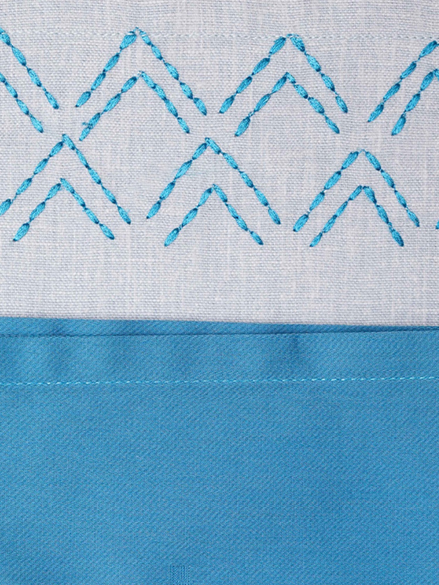 closeup of hand embroidered dinner table placemats and napkins in blue shades - 13x19 inch 