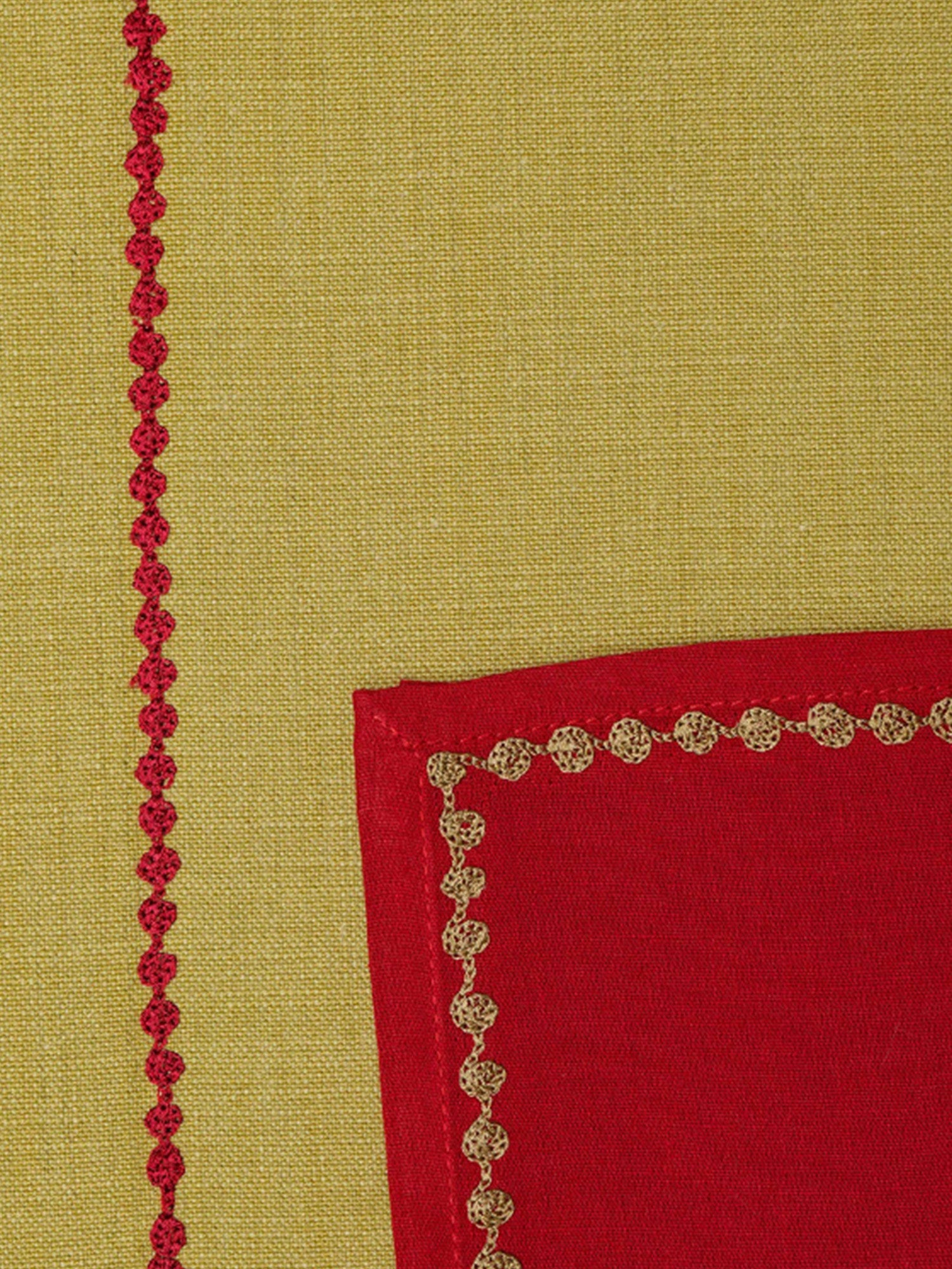 closeup of sage green colored embroidered placemats with red colored napkins in cotton fabric - 13x19 inch