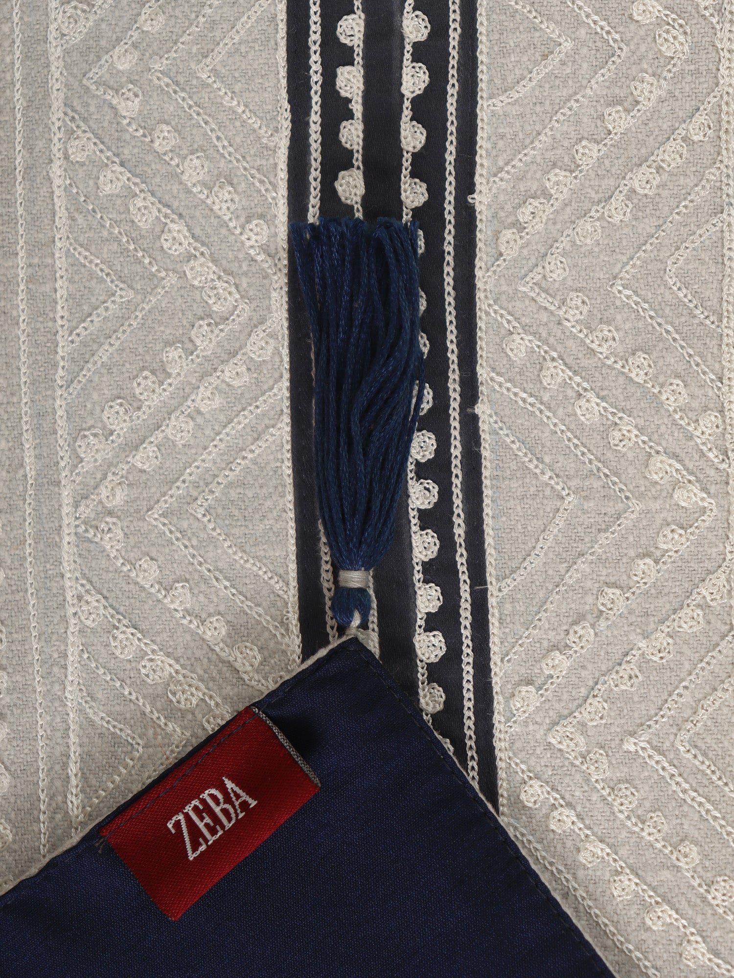 closeup embroidery on table runner with tassels - 52x84 inches.